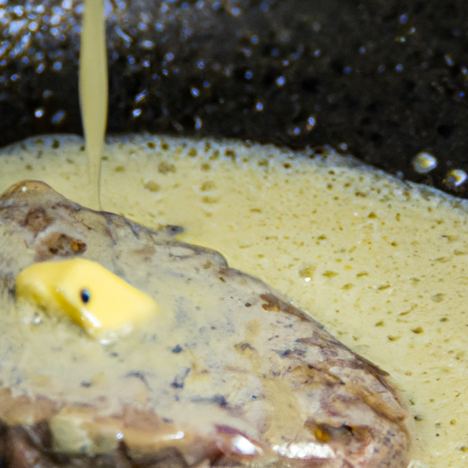 Melted garlic butter in a pan with sizzling steak